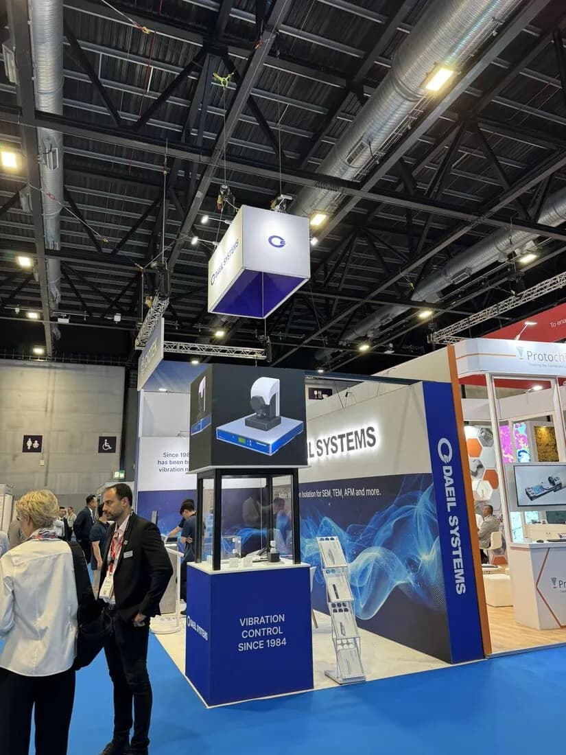 A conversation at the front of the stand, seen from the aisle.