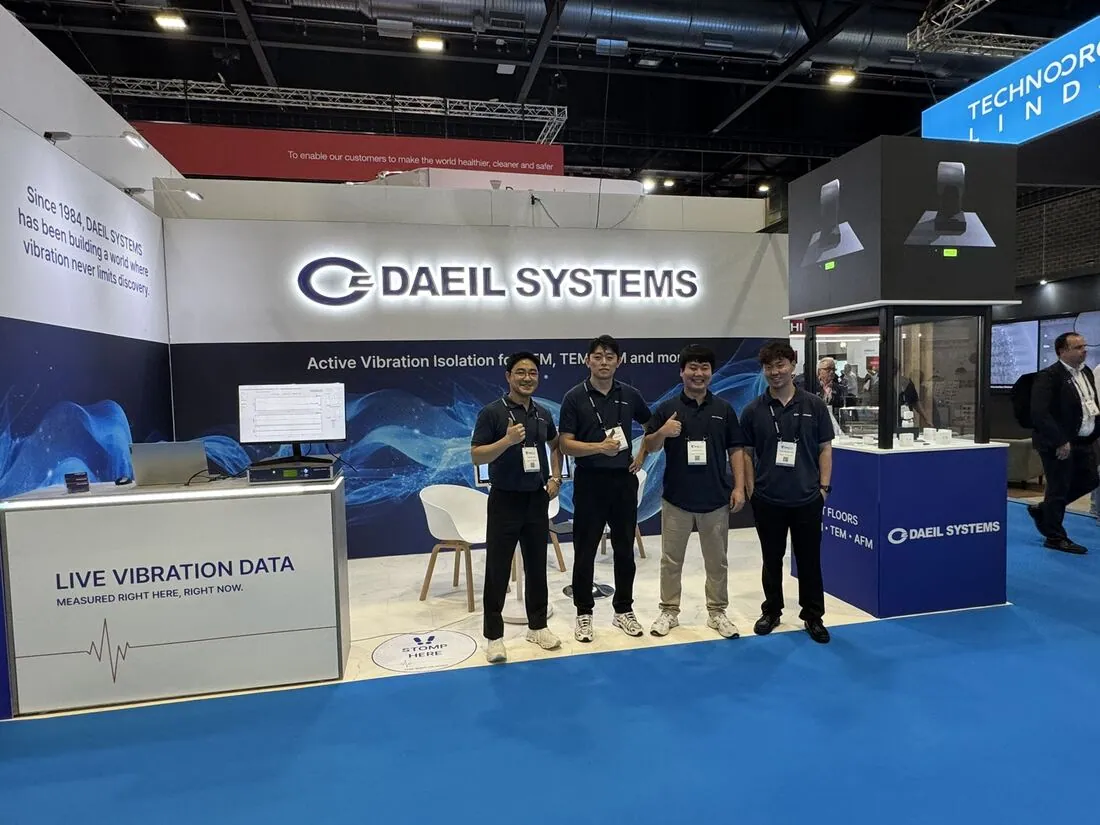 The team at the stand, the display tower behind them.
